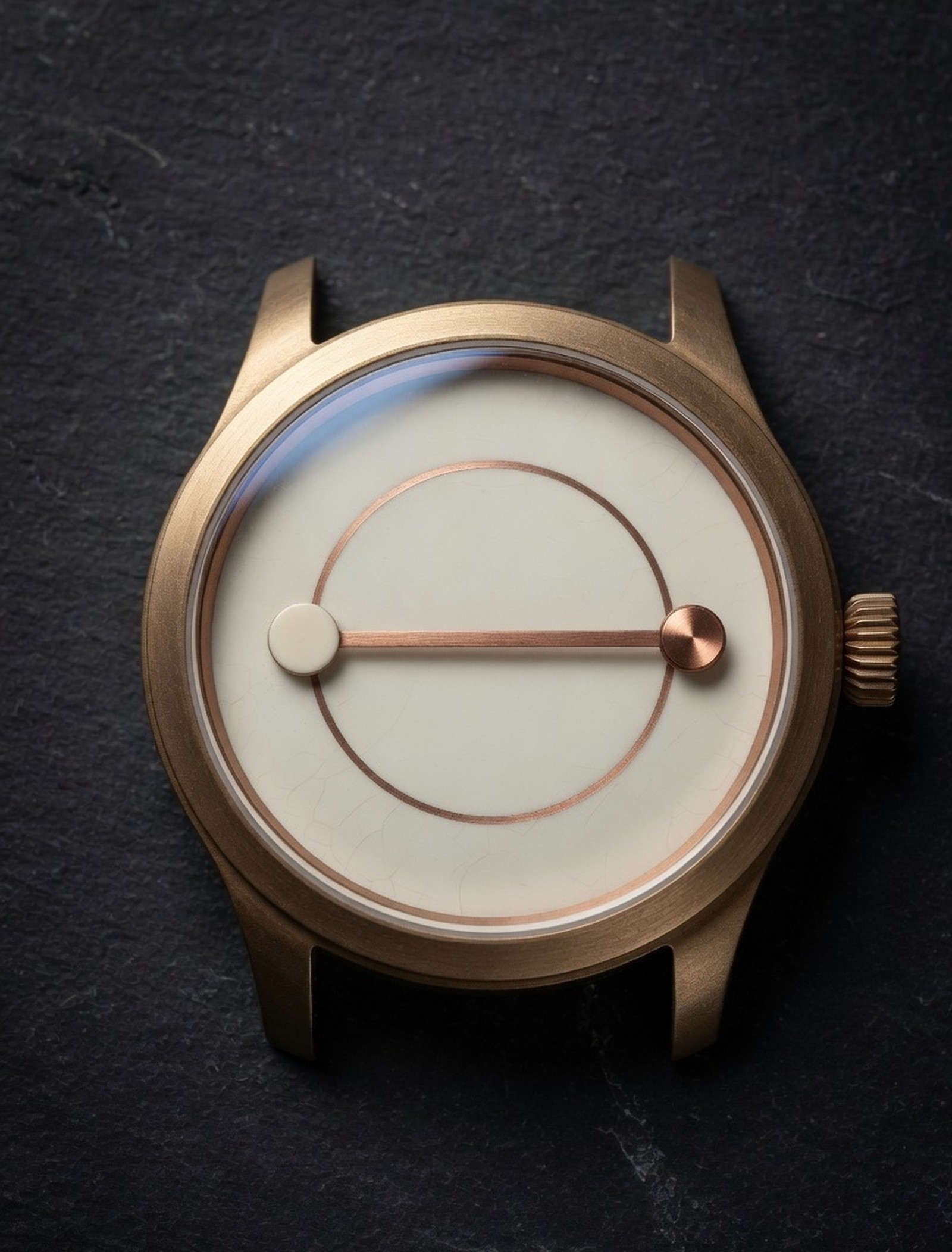 The Antipodean watch: brushed bronze case, bone enamel 24-hour dial, copper circle and diameter, no numerals.